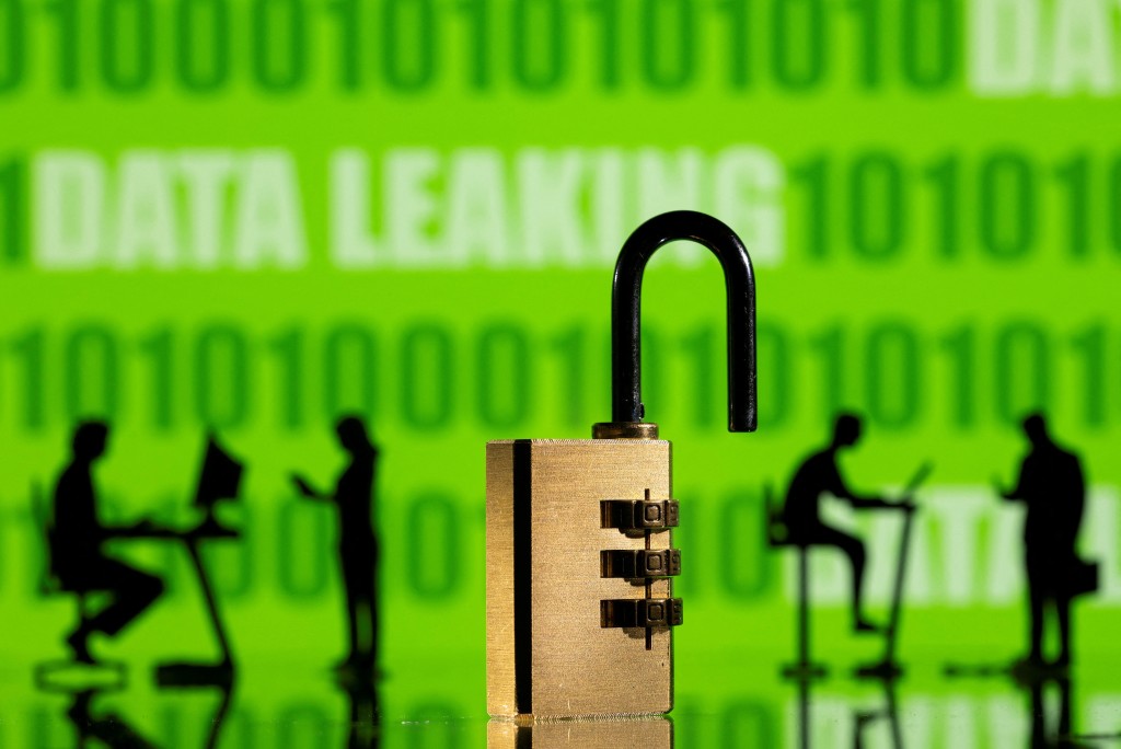 FILE PHOTO: 3D printed models of people working on computers and padlock are seen in front of a displayed DATA LEAKING words and binary code in this picture illustration created onFebruary 1, 2022. REUTERS/Dado Ruvic/Illustration/File Photo