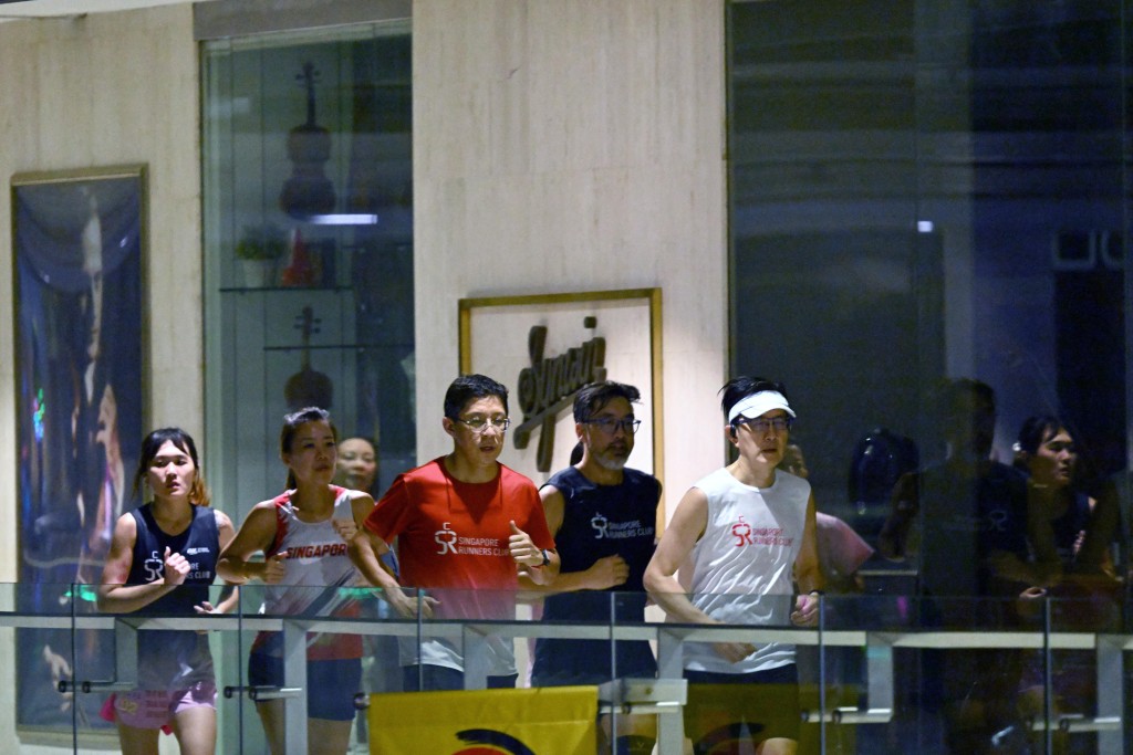 Photo by ROSLAN RAHMAN / AFP  Fitness enthusiasts run inside a mall due to haze situation outside in Singapore on October 24, 2026.