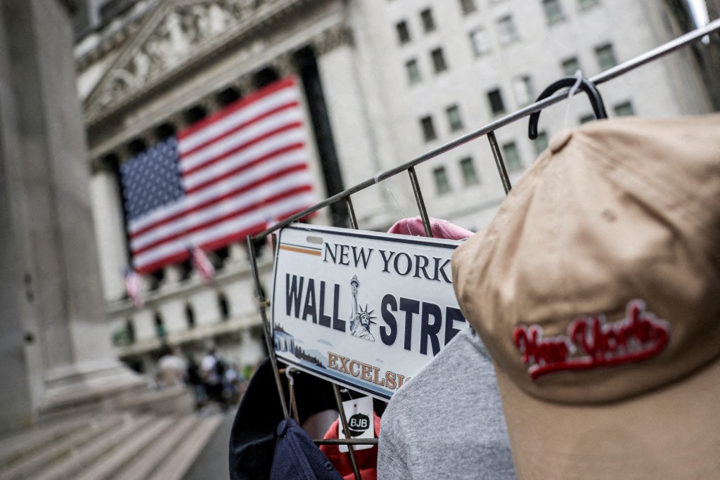 A Wall Street plate is seen on a street vendor stall outside the New York Stock Exchange in New York City, U.S., July 11, 2025. REUTERS