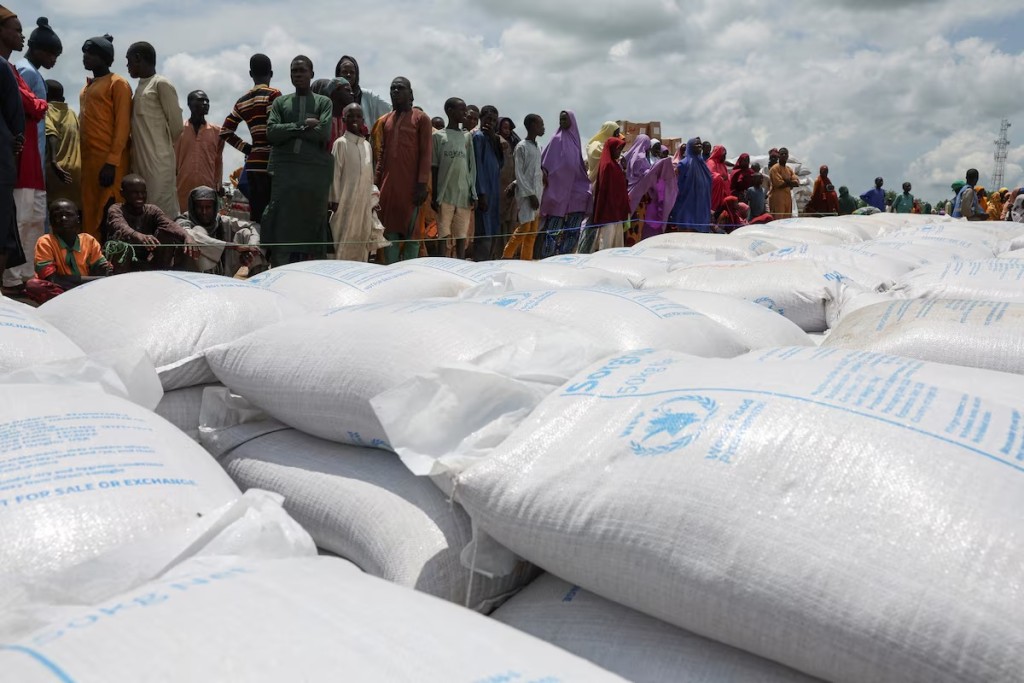 Beneficiaries from different Internally Displaced Persons camps wait in line to receive support following the exit of USAID, at a World Food Programme distribution centre in Dikwa, Borno State, Nigeria, August 27, 2025. REUTERS