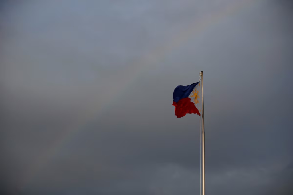 Philippines National Flag is pictured as the rainbow displays over it a day before the annual procession to celebrate Black Nazarene feast day at Quirino Grandstand in Manila, Philippines, January 8, 2020. REUTERS/Willy Kurniawan/File Photo