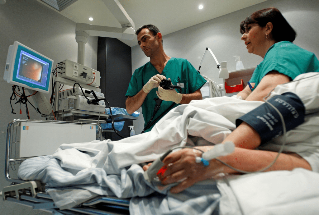 A French doctor performs a colonoscopy on a patient at the Ambroise Pare hospital in Marseille, southern France on March 25, 2008. REUTERS/Jean-Paul Pelissier/File Photo