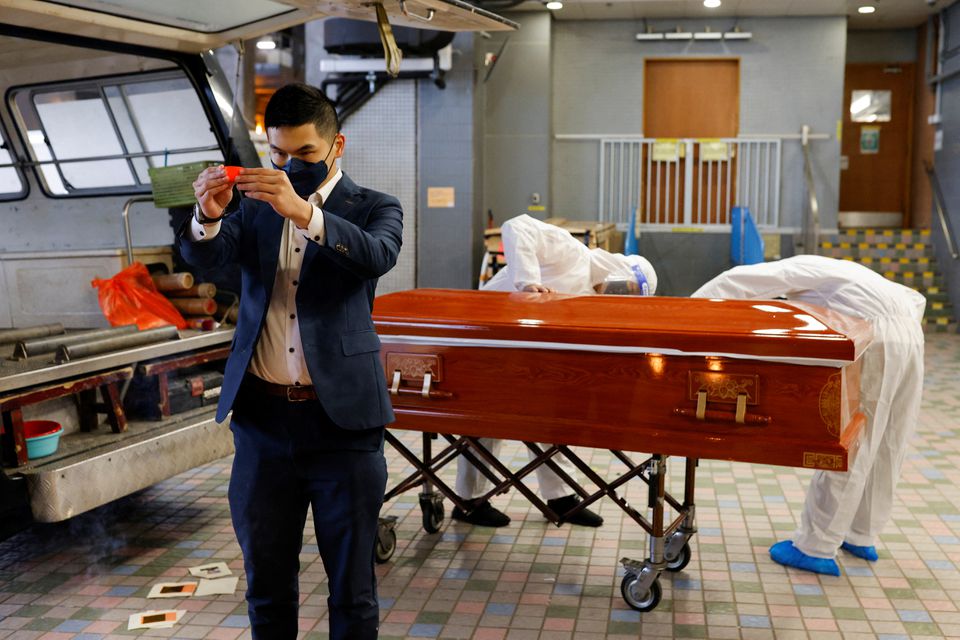 Hades Chan, funeral director of YuXiang Funeral Company, prays next to a coffin of coronavirus disease victim before cremation. (REUTERS/Tyrone Siu) Hades Chan, funeral director of YuXiang Funeral Company, prays next to a coffin of coronavirus disease victim before cremation. (REUTERS/Tyrone Siu)