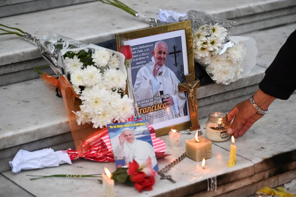 A person leaves a candle in front of a picture of Pope Francis outside the Buenos Aires' Metropolitan Cathedral, following the death of the pontiff, in Buenos Aires, Argentina, April 21, 2025. (Reuters)