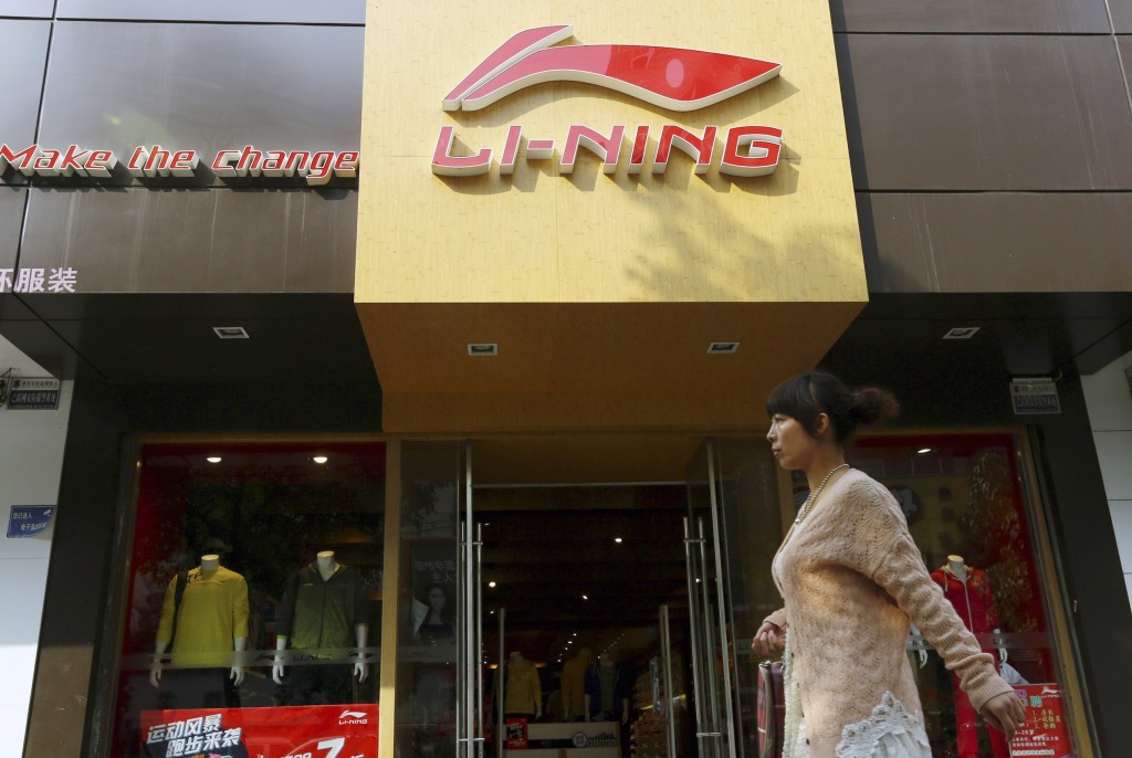 A woman walks past a Li Ning sportswear store in Huaibei, Anhui province in this October 17, 2012. REUTERS