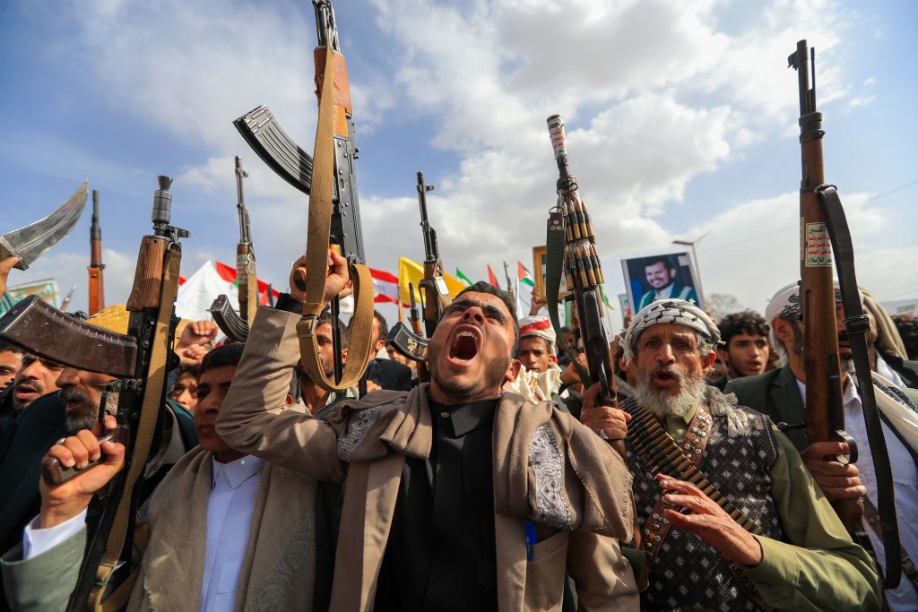 Armed Yemeni supporters of the Iran-backed Houthi movement brandish their weapons during a protest against US strikes on Iran in Sanaa on July 10, 2026. (AFP)