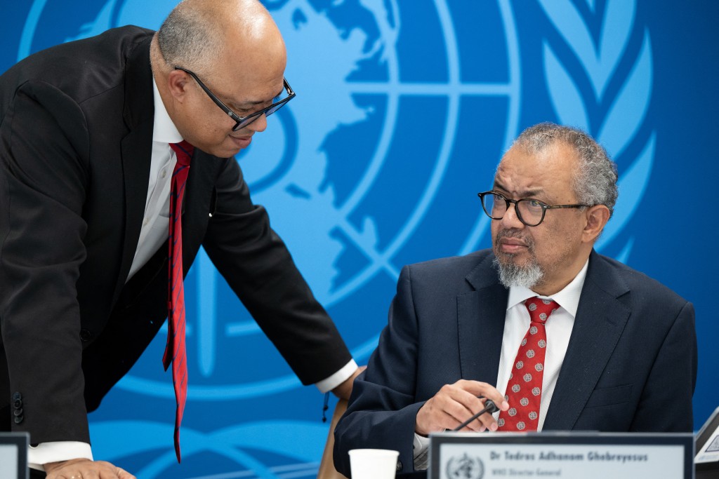 Photo by CHRISTOPHER BLACK / WORLD HEALTH ORGANIZATION / AFP  This handhout photograph taken and released on May 7, 2026 by the World Health Organization (WHO) shows its Director-General Tedros Adhanom Ghebreyesus (R) speaking with WHO Health Emergencies Programme executive director Chikwe Ihekweazu prior to a virtual press conference on the hantavirus cluster linked to a cruise ship travel, at the WHO headquarters, in Geneva.