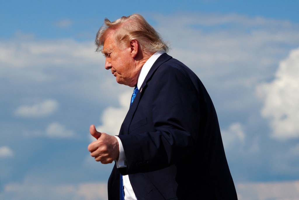 US President Donald Trump flashes a thumbs up while stepping off Air Force One upon arrival at Morristown Municipal Airport in Morristown, New Jersey, on July 31, 2026. (AFP)