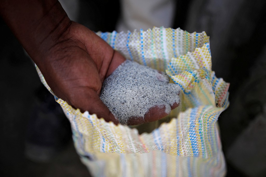 A man displays a coltan ore at the SMB mine near the town of Rubaya in the Eastern Democratic Republic of Congo, August 13, 2019. Picture taken August 13, 2019. (Reuters)