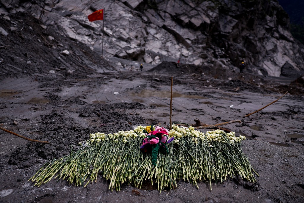 Flowers are placed on mud as tribute at the core disaster-hit area at Gyirong Port amid rescue efforts following the August 26 mudslide, during an organised media tour in Shigatse, Tibet Autonomous Region, China, September 6, 2026. REUTERS/Tingshu Wang/Pool 