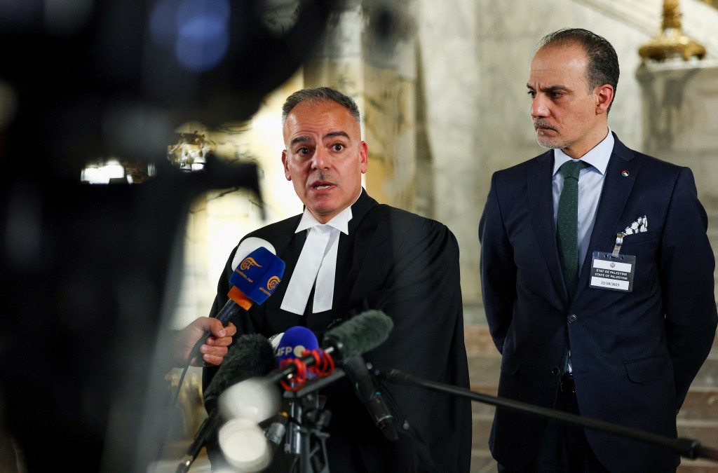 Ardi Imseis speaks to the media next to Ammar Hijazi, ambassador and permanent Palestinian representative to international organizations in the Netherlands, on the day the International Court of Justice (ICJ) delivers a non-binding Advisory Opinion on Israel's obligations regarding the presence and activities of the United Nations and other international actors in the occupied Palestinian territory, in The Hague, Netherlands, October 22, 2025. REUTERS/Piroschka van de Wouw