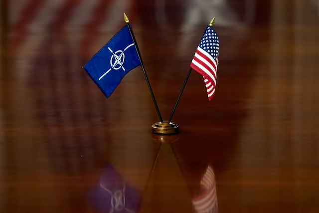 NATO and U.S. flags are set on the table as U.S. Defense Secretary Pete Hegseth and NATO Secretary General Mark Rutte meet at the Pentagon in Washington, D.C., U.S., April 24, 2025. REUTERS/Nathan Howard