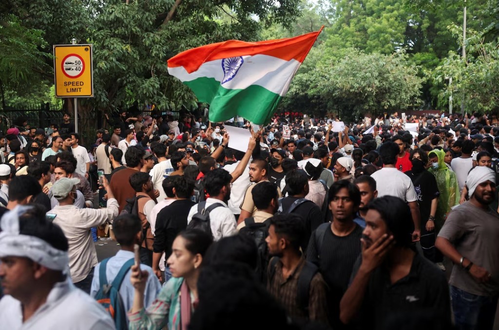 A supporter of India's Cockroach Janata Party (CJP) holds an Indian national flag at the ongoing protest site, a few days after thousands of protesters marched towards parliament demanding the resignation of Education Minister Dharmendra Pradhan over National Eligibility cum Entrance Test (NEET) examination paper leaks, at Jantar Mantar in New Delhi, India, July 23, 2026. REUTERS/Francis Mascarenhas