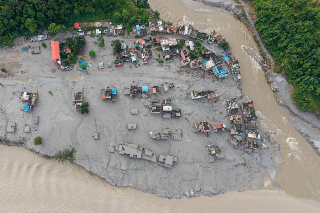Photo by PRABIN RANABHAT / AFP An aerial view shows houses lying deluged in sludge after flash floods at Devighat, Bidur Municipality in Nepal's Nuwakot district on August 27, 2026.