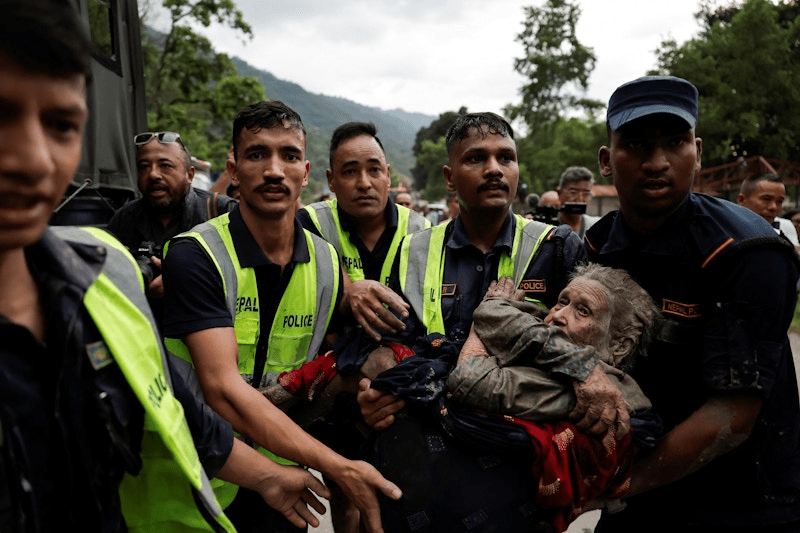 Police officers carry a survivor in Nuwakot district, Nepal, August 26, 2026. REUTERS/Navesh Chitrakar