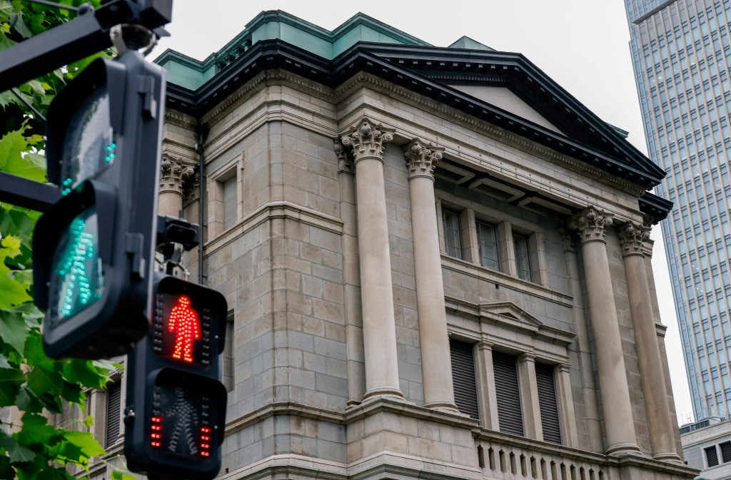 Traffic signs in front of the Bank of Japan building in Tokyo, Japan, June 15, 2026. REUTERS