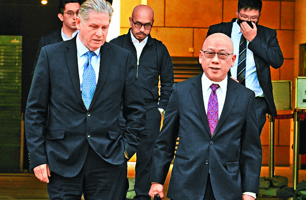 Robert Pang leaves court with a colleague. Robert Pang leaves court with a colleague.