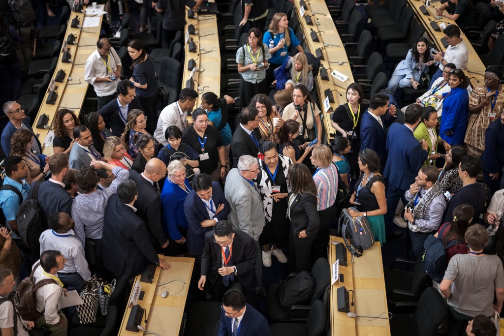 Delegates speak together after talks on a global treaty on combating plastic pollution were extended an extra day, late on August 14, 2025 in Geneva. Talks on striking a global treaty on combating plastic pollution were extended an extra day into August 15 but with no clear endgame in sight. Ten days of negotiations at the United Nations in Geneva were due to wrap up on August 14, 2025, but with 23 minutes of the day left, the talks were prolonged. (Photo by Fabrice COFFRINI / AFP)