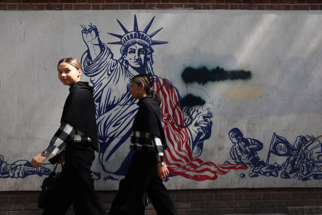 People walk near an anti-U.S. mural in Tehran, Iran, June 30, 2026. Majid Asgaripour/WANA (West Asia News Agency) via REUTERS