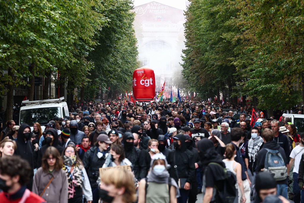Protestors walk in Lille, northern France, on September 18, 2025, during a day of nationwide strikes and protests called by unions over France's national budget. France is bracing for a day of nationwide protests on September 18, 2025, with a source close to the authorities saying some 800,000 people are expected to take to the streets. (AFP)