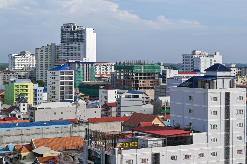 Photo by TANG CHHIN SOTHY / AFP  A general view shows high-rise buildings in Poipet town in Cambodia's western Banteay Meanchey province on the border with Thailand, on June 25, 2025.