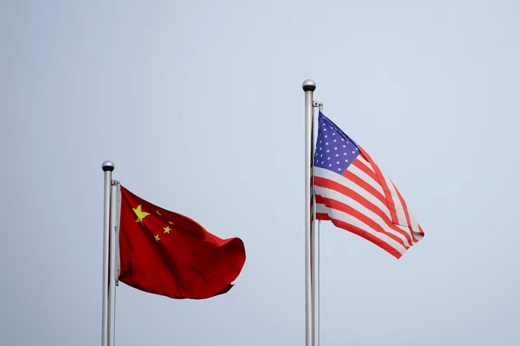 Chinese and U.S. flags flutter outside a company building in Shanghai, China April 14, 2021. REUTERS/Aly Song//File Photo