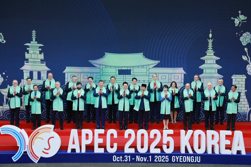 This handout photo from APEC 2025 KOREA via Yonhap taken and released on November 1, 2025 shows South Korea's President Lee Jae Myung (C) posing for a group photo with leaders from the Asia-Pacific Economic Cooperation (APEC) in Gyeongju. (Photo by Handout / various sources / AFP)