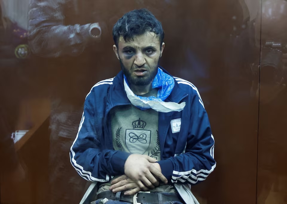 Dalerdzhon Mirzoyev, a suspect in the shooting attack at the Crocus City Hall concert venue, sits inside behind a glass wall of an enclosure for defendants at the Basmanny district court in Moscow, Russia March 24, 2024. (REUTERS/Shamil Zhumatov)