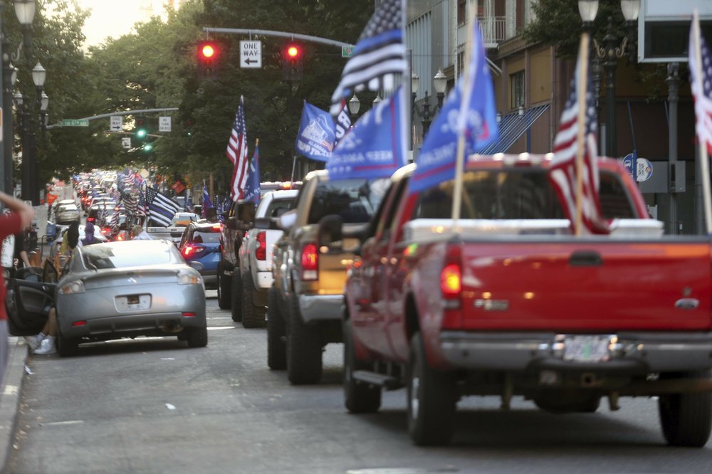 A caravan of supporters of President Donald Trump drive in downtown Portland, Oregon, Saturday.