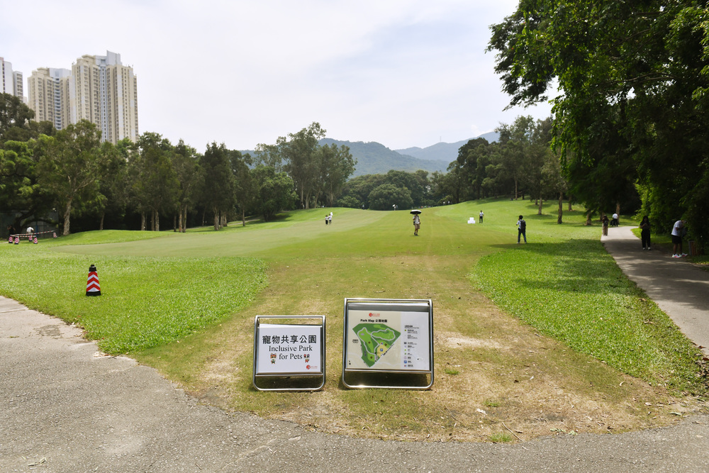 People walk in as gates open for the first time, allowing visitors to the pet park and walking trail on land taken back from the Old Course of the Hong Kong Golf Club. SING TAO