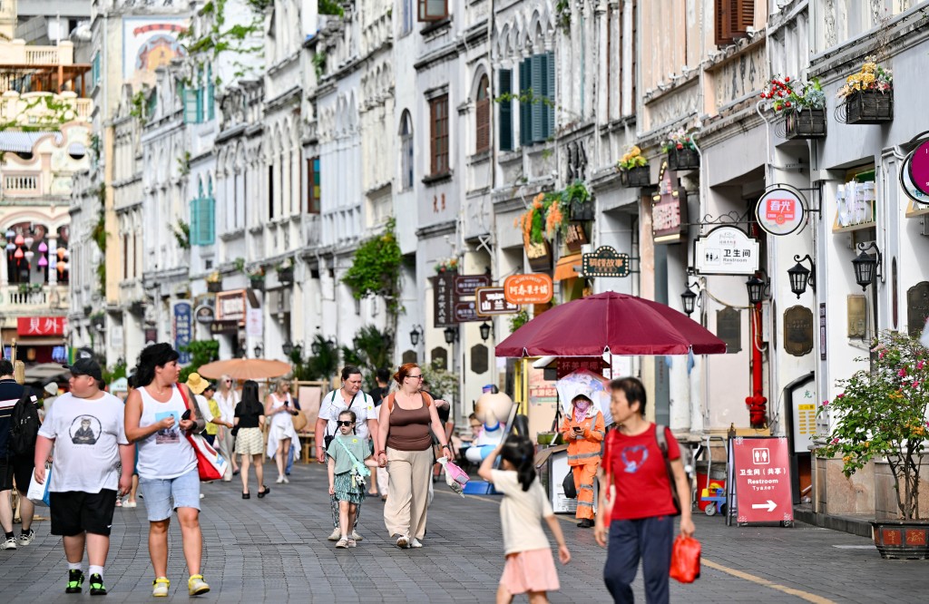 Foreign tourists visit the Qilou Old Street in Haikou, south China's Hainan Province, May 9, 2026. XINHUA