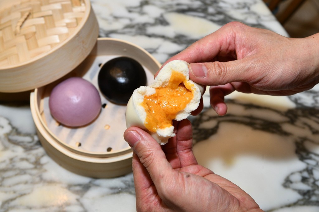 Golden Lava Custard, Lipu Taro Lava and Black Sesame Lava Buns (Jade Garden) - Jade Garden serves three indulgent lava buns: salted egg yolk custard with a molten center, fragrant Lipu taro, and rich black sesame, each wrapped in a soft steamed bun.
