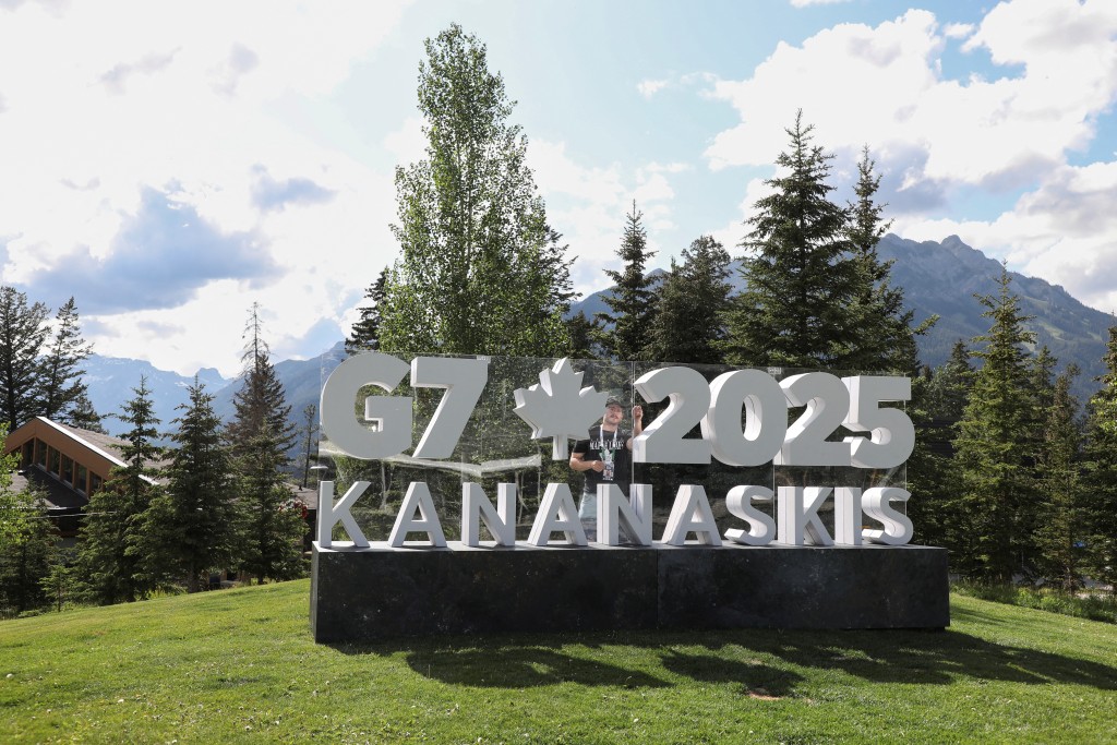 A worker prepares a sign ahead of the G7 summit at a satellite location in Banff, Alberta, Canada, June 14, 2025. (Reuters)