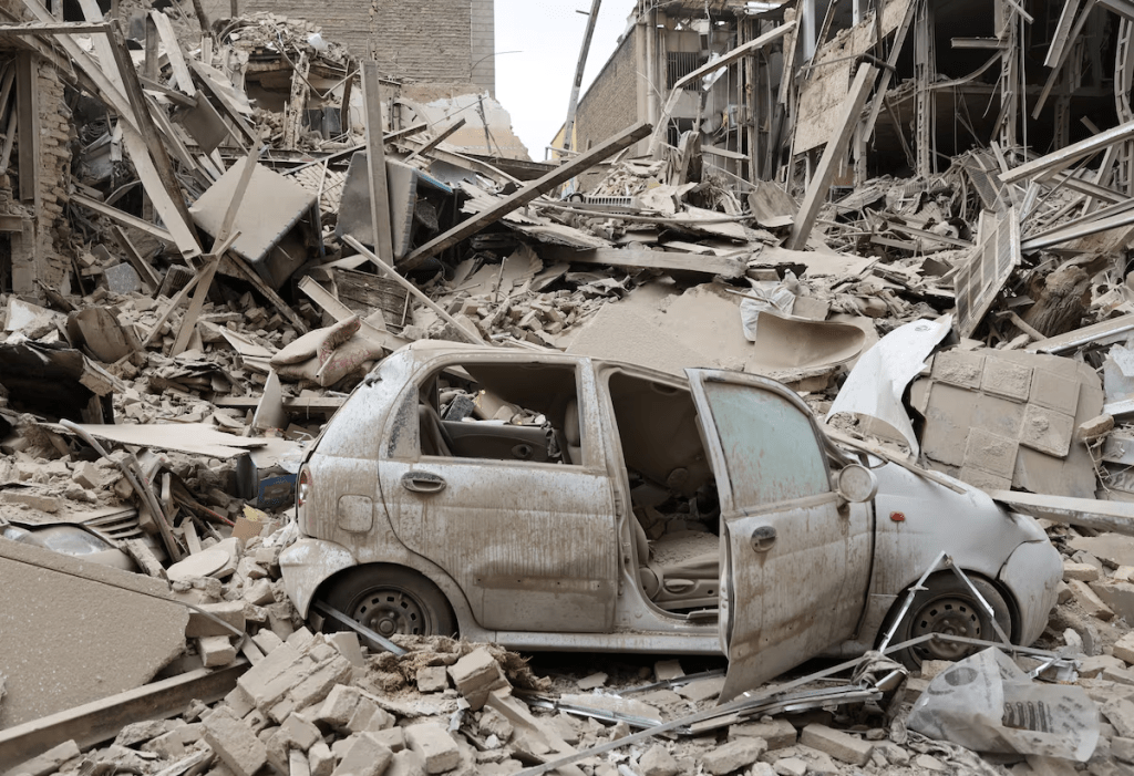 A destroyed vehicle amid rubble at the site of a strike on a residential building, amid the U.S.-Israeli conflict with Iran, in Tehran, Iran, March 16, 2026. Majid Asgaripour/WANA (West Asia News Agency) via REUTERS