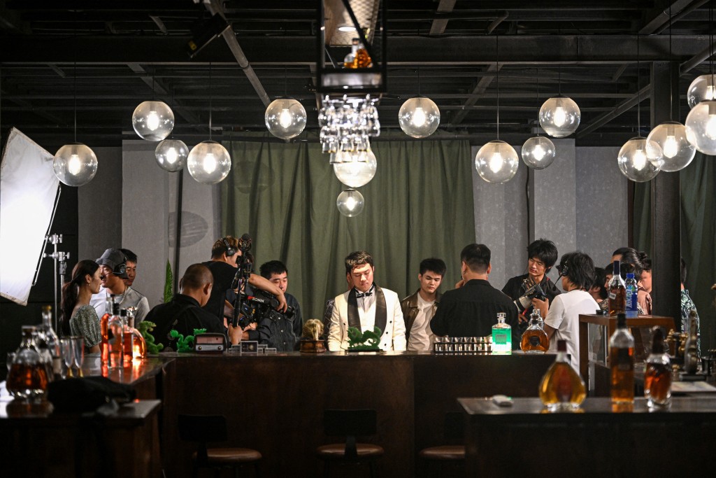 Photo by JADE GAO / AFP  The photo taken on October 10, 2025 shows the cast and crew of a Chinese microdrama filming a scene at a microdrama film studio in Shanghai.