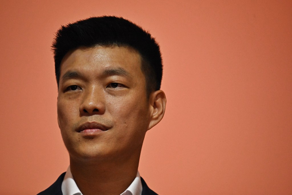 Photo by LILLIAN SUWANRUMPHA / AFP  Natthaphong Ruengpanyawut, member of parliament and leader of Thailand’s opposition People’s Party, is pictured during a press conference alongside fellow party MPs accused of proposing amendments to the lese-majeste law, in Bangkok on April 24, 2026.