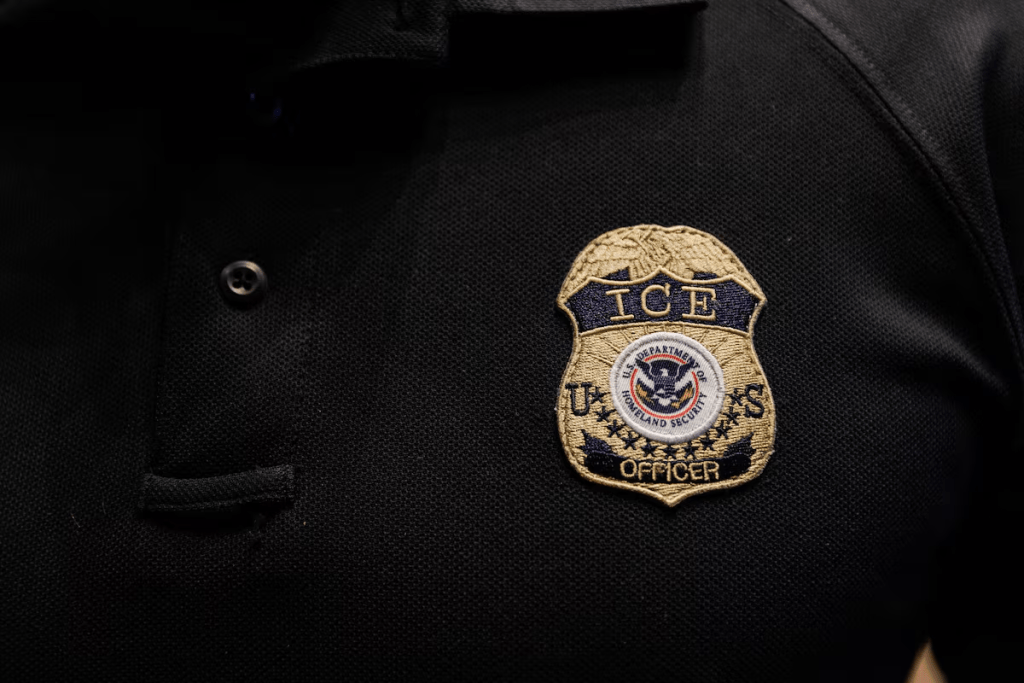 The badge of U.S. Immigration and Customs Enforcement (ICE) is embroidered on a polo shirt of an ICE employee in Arlington, Texas, U.S. August 26, 2025. REUTERS/Shelby Tauber