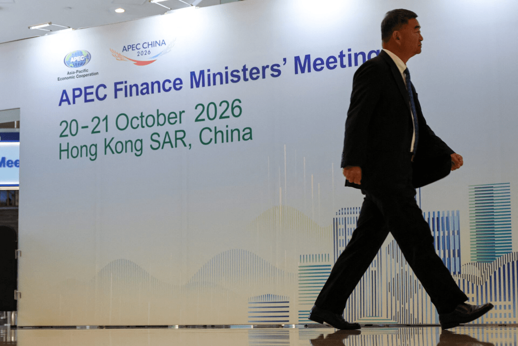 A man walks past a sign for the APEC Finance Ministers' Meeting in Hong Kong, China, October 20, 2026. REUTERS/Tyrone Siu