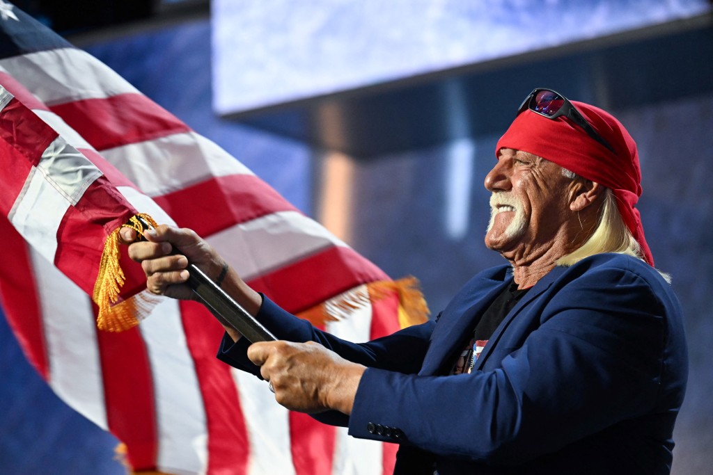 US pro-wrestler Hulk Hogan waves the US flag as he speaks during the last day of the 2024 Republican National Convention at the Fiserv Forum in Milwaukee, Wisconsin, on July 18, 2024. (AFP)