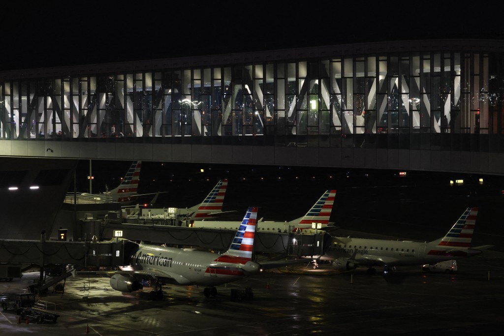 Planes sit at gates after a ground stoppage was issued following a collision between an Air Canada Express CRJ-900 and a Port Authority fire truck at LaGuardia Airport in New York, on March 23, 2026. (AFP)