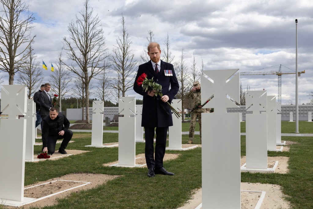 Britain's Prince Harry, Duke of Sussex, pays tribute as he lays flowers to the graves of unknown Ukrainian servicemen at The National War Memorial Cemetery in Kyiv on April 24, 2026, amid Russian invasion of Ukraine. (Photo by Serhii Okunev / AFP)