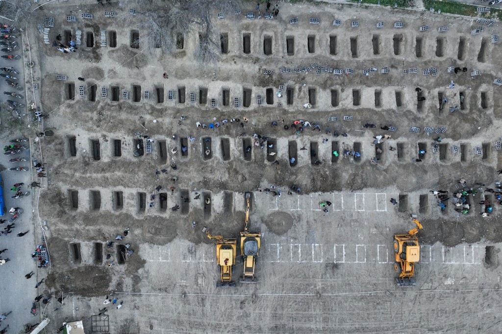 In this aerial handout picture released by the Iranian Press Center, mourners dig graves during the funeral for children killed in a reported strike on a primary school in Iran’s Hormozgan province in Minab on March 3, 2026. (AFP)