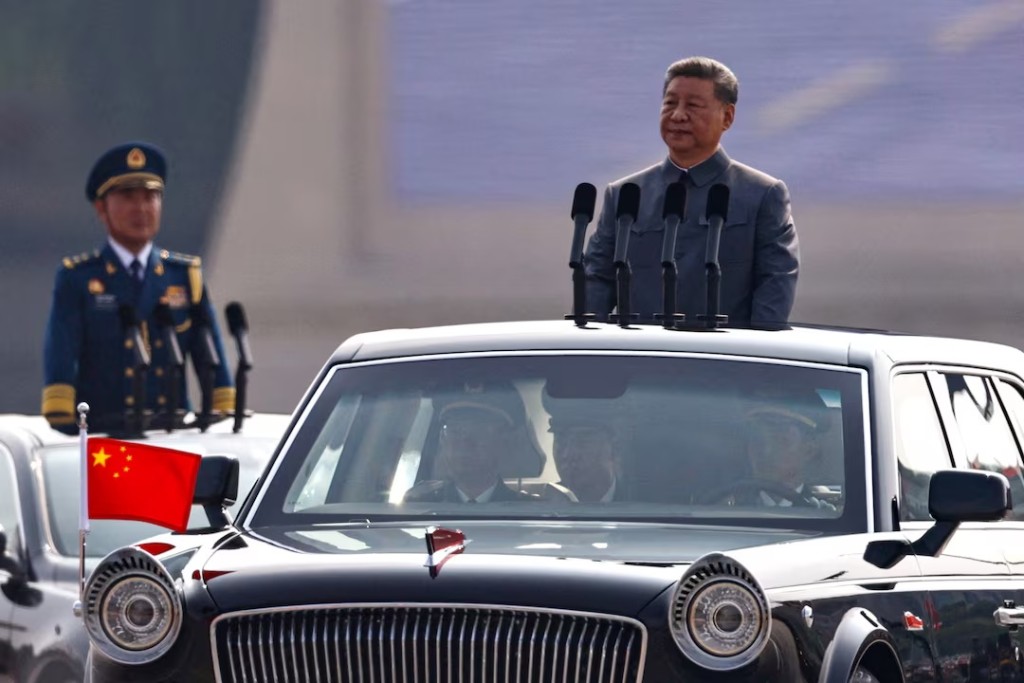 Chinese President Xi Jinping stands in a car to review the troops during a military parade to mark the 80th anniversary of the end of World War Two, in Beijing, China, September 3, 2025. REUTERS/Tingshu Wang/File Photo