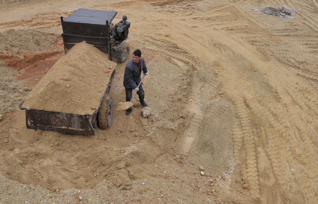 A labourer works at a site of a rare earth metals mine at Nancheng county, Jiangxi province March 14, 2012. REUTERS