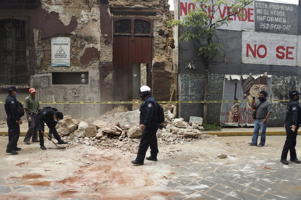 A policeman removes rubble from a building damaged by an earthquake in Oaxaca, Mexico, Tuesday, June 23, 2020. The earthquake was centered near the resort of Huatulco, in the southern state of Oaxaca. A policeman removes rubble from a building damaged by an earthquake in Oaxaca, Mexico, Tuesday, June 23, 2020. The earthquake was centered near the resort of Huatulco, in the southern state of Oaxaca.