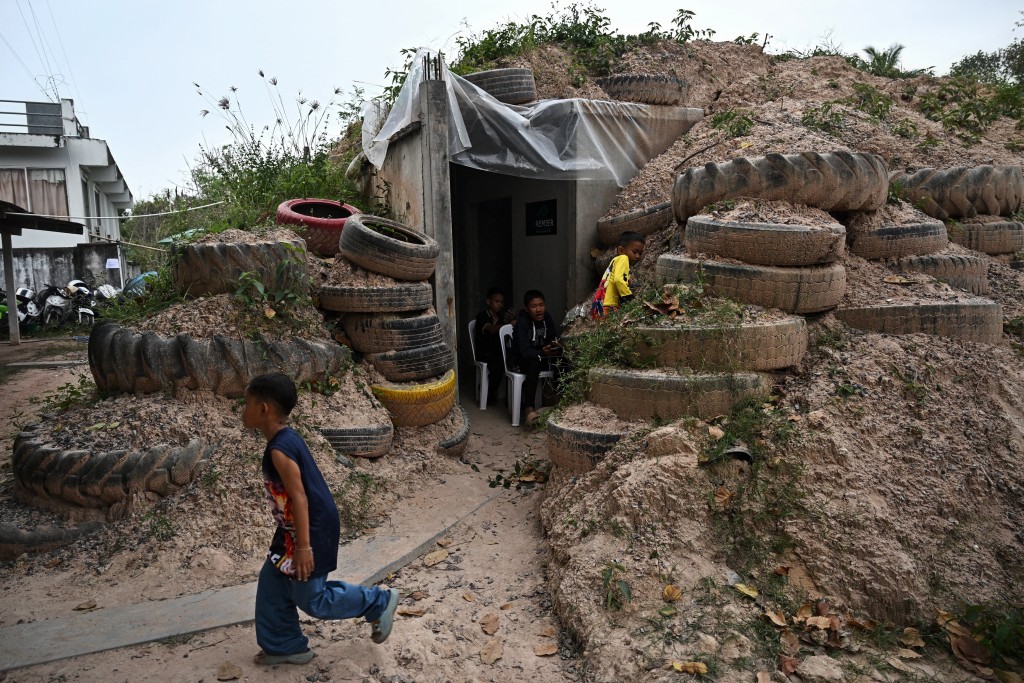 Children play around a bunker in Surin province on December 10, 2025, during clashes along the Thai-Cambodia border. (AFP)