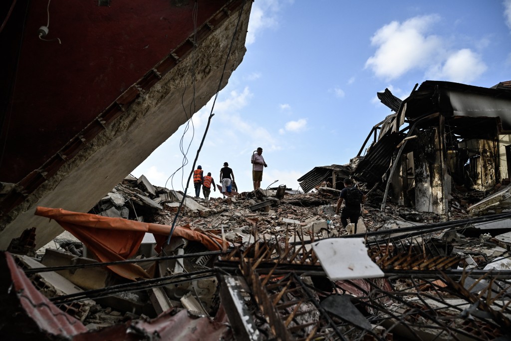 Rescuers search for possible victims at a collapsed building following twin earthquakes, in Caraballeda, La Guaira State, some 40 km northeast of Caracas, on June 27, 2026. (AFP)