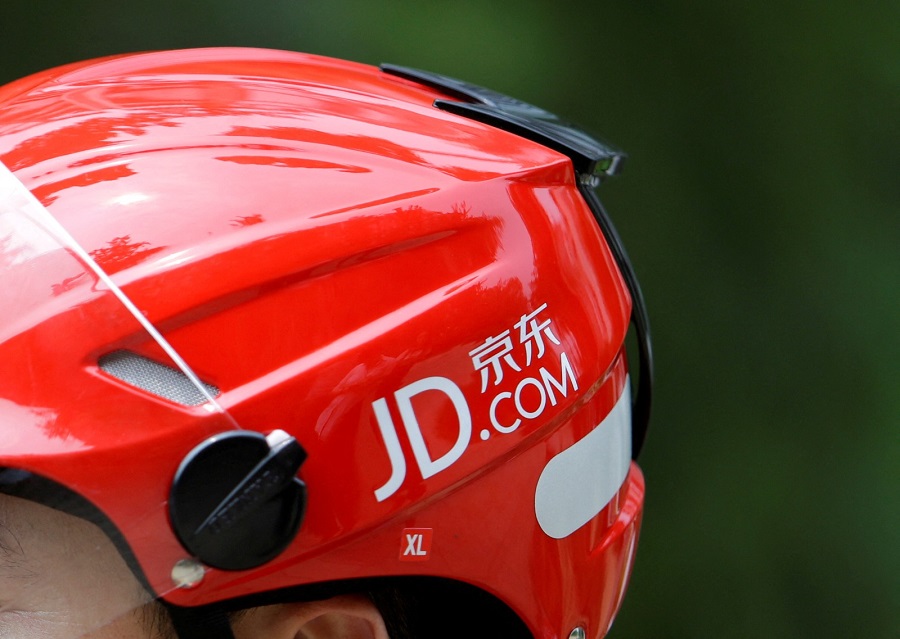 JD.com's logo is seen on a delivery man's helmet in Beijing in June 2014. Photo by REUTERS   