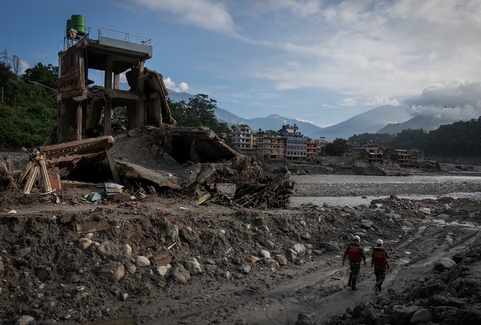 Members of the Nepal Army rescue team walk past the damaged houses, following deadly flash floods and a mudslide, in Trishuli, Nuwakot district, Nepal, September 8, 2026. REUTERS/Adnan Abidi 