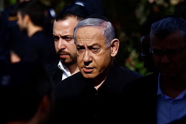 Israeli Prime Minister Benjamin Netanyahu attends the funeral of Gal Meir Eisenkot, 25, an Israeli solider and the son of Israeli cabinet minister and former military chief Gadi Eisenkot, who was killed in northern Gaza during the ongoing ground operation by Israel's military in the Gaza Strip, in Herzliya, Israel, December 8, 2023. REUTERS/Clodagh Kilcoyne